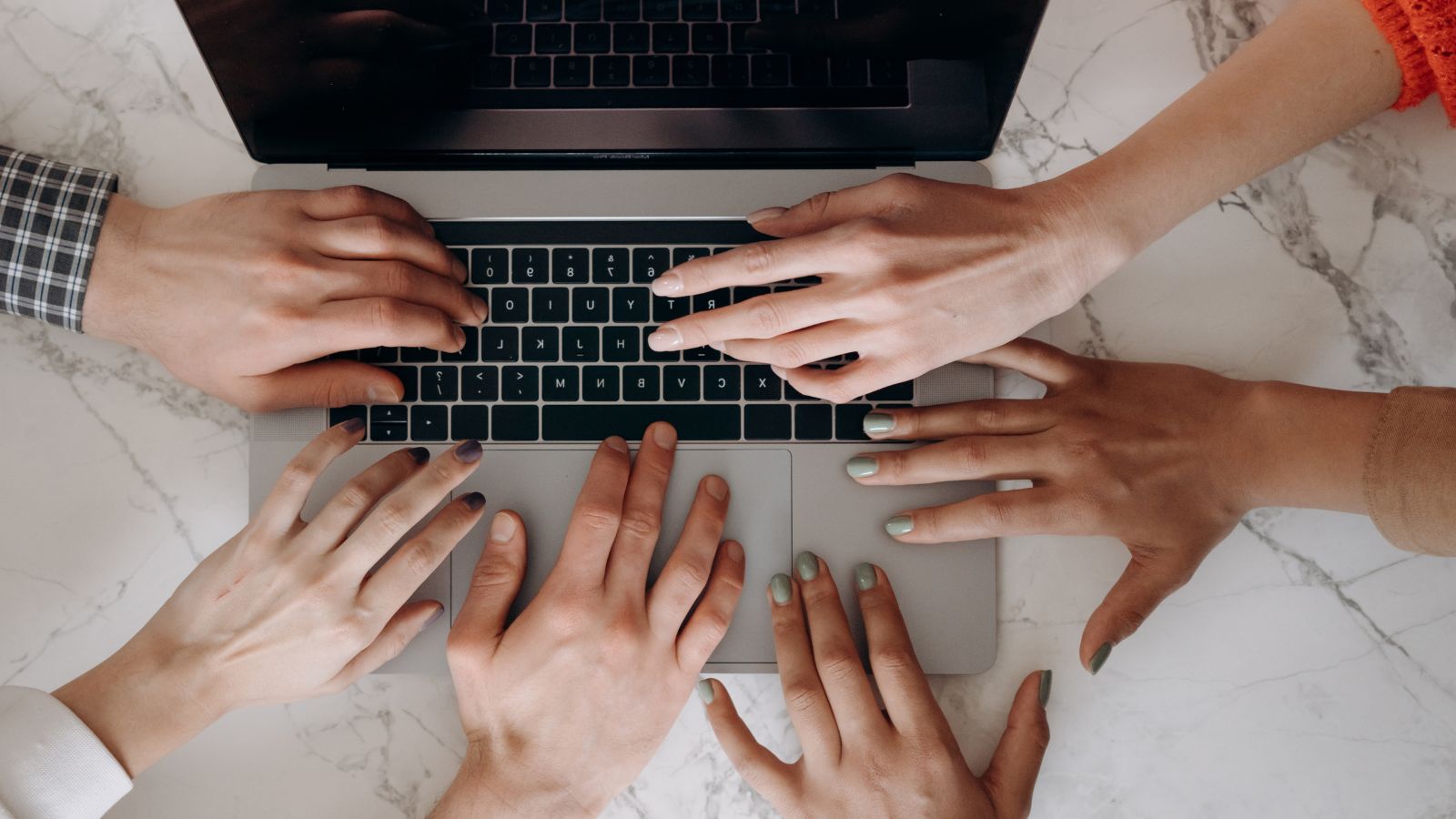 Accessible Tech for All banner image Image of several hands touching a laptop.