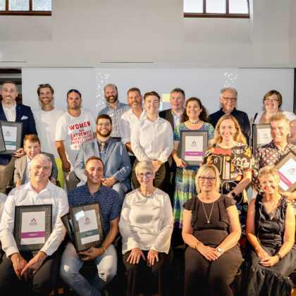 Finalists and winners of the Australian Access Awards pose on stage for a photo.