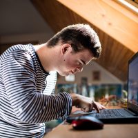 Person typing on a laptop keyboard