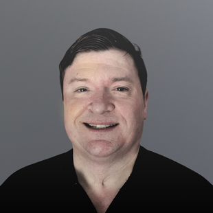 Scott is smiling at the camera. He is wearing a black shirt.