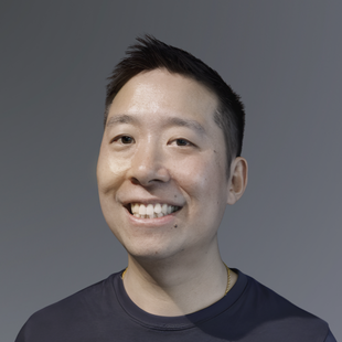 Stanley is beaming at the camera. He is wearing a black shirt.