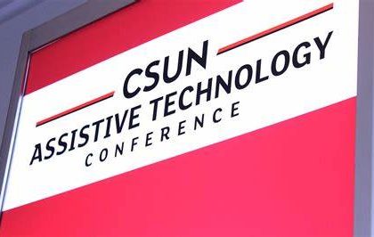 An image of the CSUN Assistive Technology Conference logo, on a screen, with a red background.
