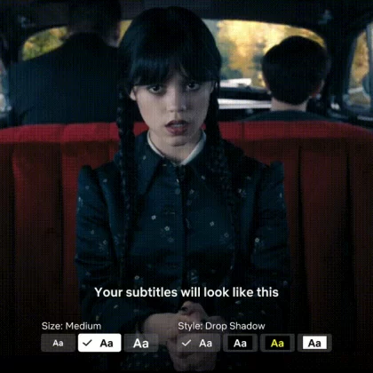 The character Wednesday Addams all in black, sits facing the camera in the back of a car. The caption on the bottom of the image says "your subtitles will look like this" and underneath are customisable options.