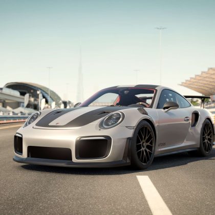 An image of a grey sportscar on a racing track.