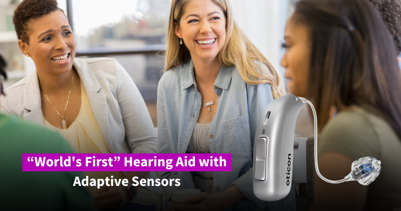 Image is of three women sitting, facing each other and laughing. The text says "World's First Hearing Aid with Adaptive Sensors". To the right is the hearing device, in silver. 