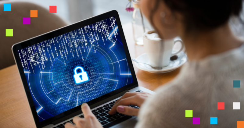 Image is of woman typing at a laptop. The laptop screen has code and a padlock.